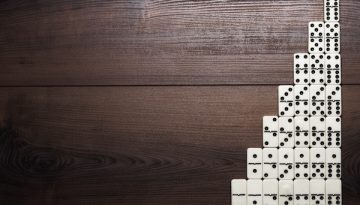 full set of domino pieces on wooden table