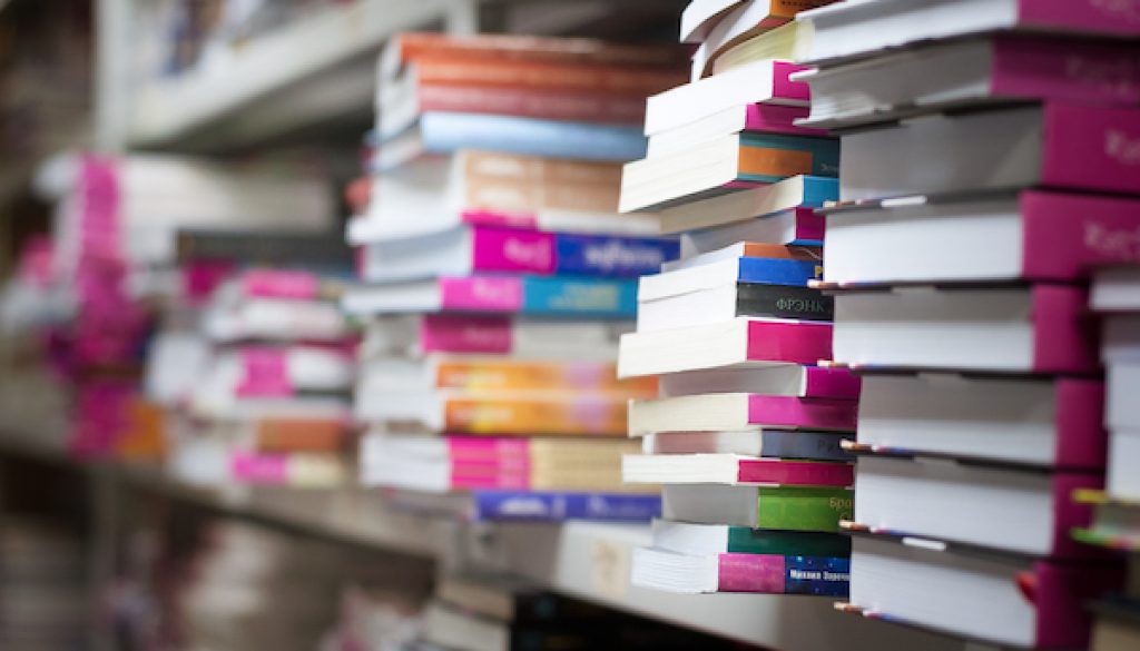 piles of books on the shelves of the archive