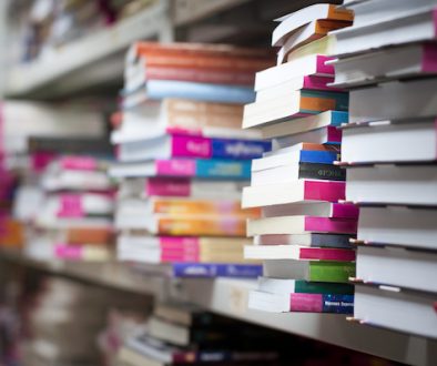 piles of books on the shelves of the archive