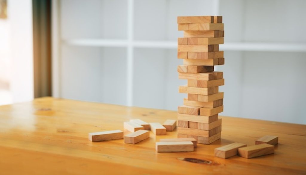 Wood blocks stacks game with planning strategy of project management.