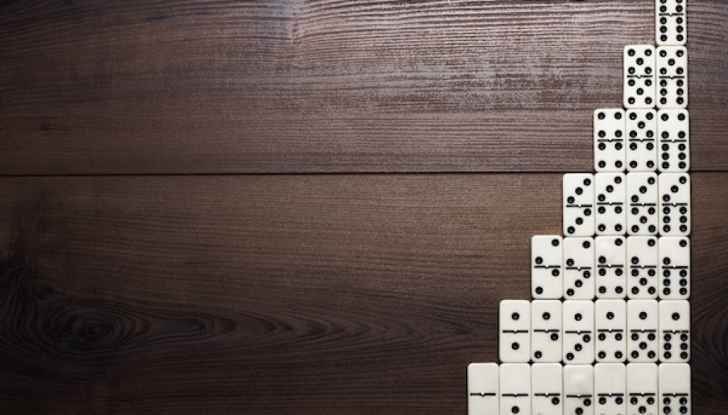 full set of domino pieces on wooden table