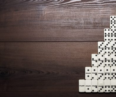 full set of domino pieces on wooden table