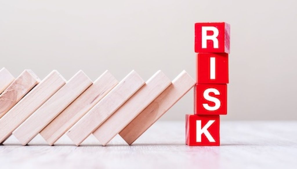 Red RISK cube blocks stop falling blocks on table. fall Business, planning, Management, Solution, Insurance and strategy Concepts