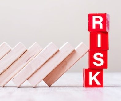 Red RISK cube blocks stop falling blocks on table. fall Business, planning, Management, Solution, Insurance and strategy Concepts
