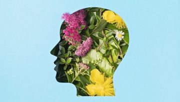 Papercut head with green leaves and flowers. Mental health, emotional wellness, contented emotions, self care, psychology, green thinking, ecology