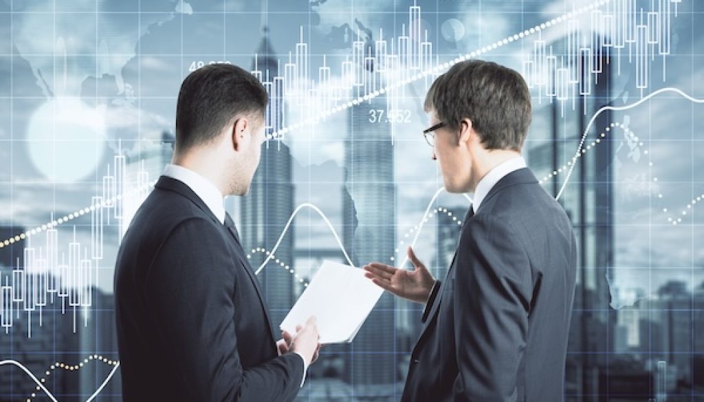 Two businessmen analyze business report 2026’ya Girerken Yatırımcı İlişkilerinin Artan Stratejik Rolü